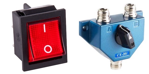 on the left, red switch with a 1 on top, a 0 on the bottom, and turned to the 1 position + on the right a coaxial selector with the input on the bottom, an A and B position of top, and the central nob set to the A position